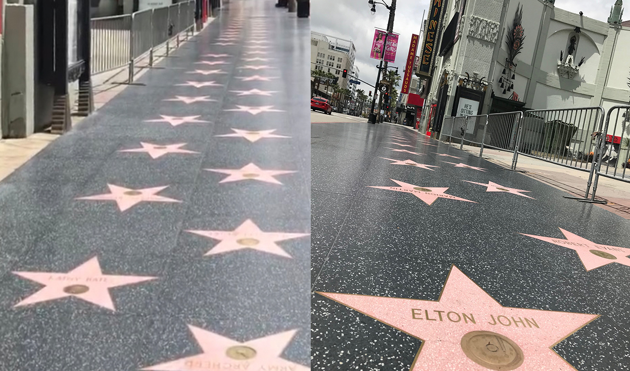 a sign on a sidewalk with Hollywood Walk of Fame in the background