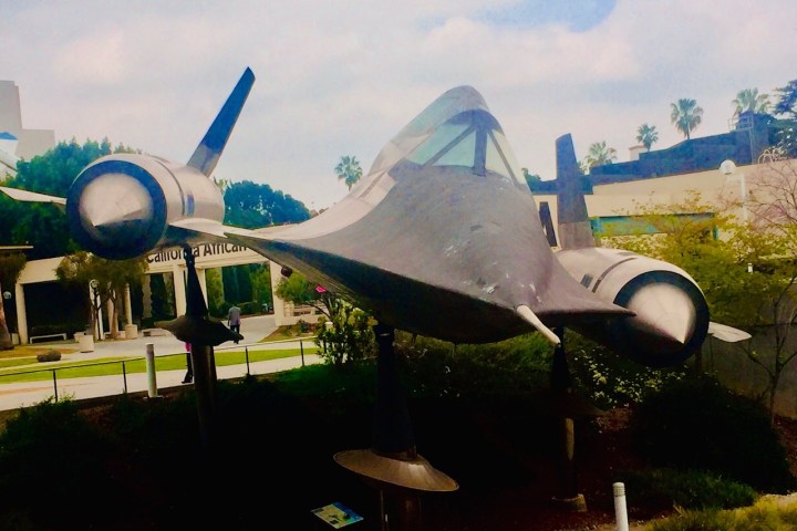 a plane sitting on top of a grass covered field